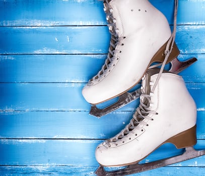 a pair of worn white leather skates for figure skating photo