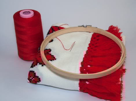 Traditional embroidered towel with red thread on white background photo