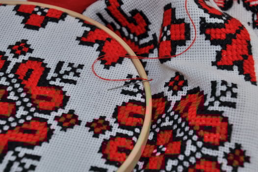 Traditional embroidered towel with red thread, macro photo