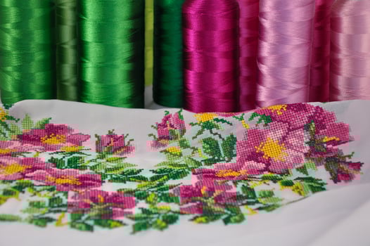 cross-stitch flower ornament on a fabric photo
