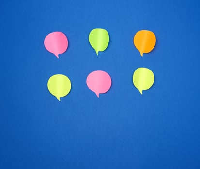 multicolored empty paper stickers in the form of clouds on a blue background photo