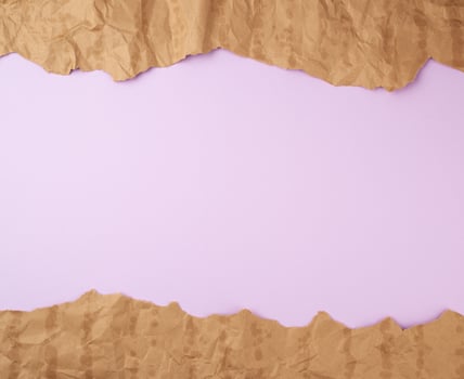 abstract lilac background with brown torn paper elements photo