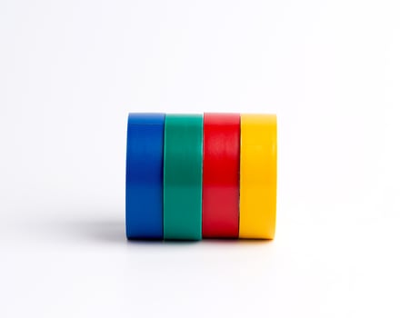 full coils of multi-colored insulating tape on a white background photo