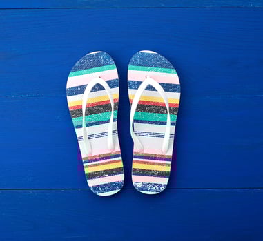 Flip flop in flat style on blue wooden background photo