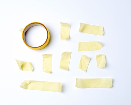set of various pieces of yellow sticky paper tape on a white background photo