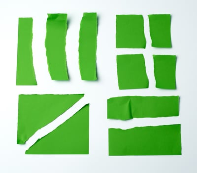 various blank pieces of green paper on white background, photo