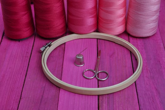Several of red thread reel in a hoop photo