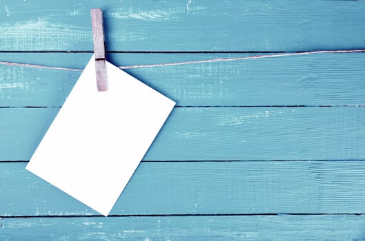 Blank envelope hanging on rope on wooden clothespin photo