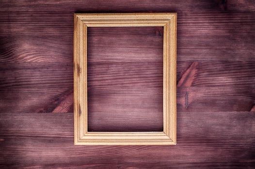 Empty wooden frame on a wood textured surface photo