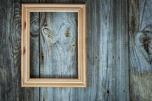 empty wooden frame on aged gray wooden wall photo