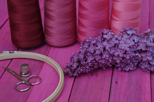 Threads in red tones with wooden hoops photo