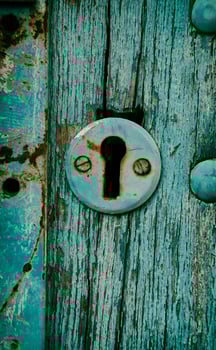Vintage keyhole in a old door photo