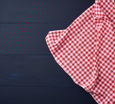 white red checkered kitchen towel on a blue wooden background photo