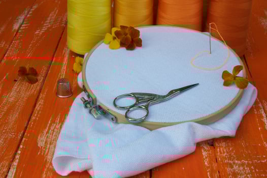 stylized photo in the orange range of items for sewing and embroidery