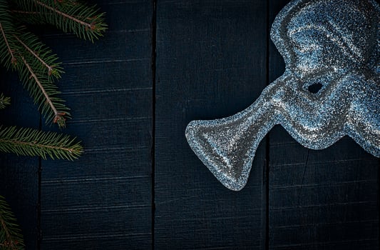 brilliant figure of an angel with a trumpet on a black wooden background photo