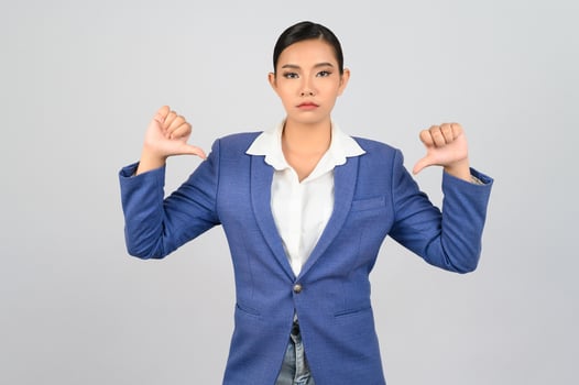 Young beautiful woman in formal clothing for officer with thumb down posture photo