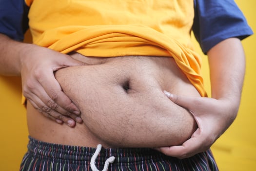 young men holding his belly fat photo