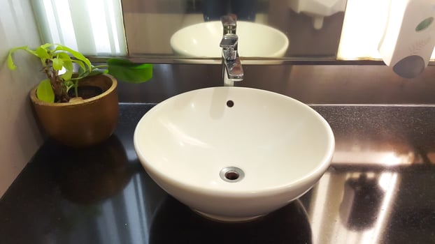 Round ceramic wash basin. Stylish sink bowl and tap. Bathroom interior. photo