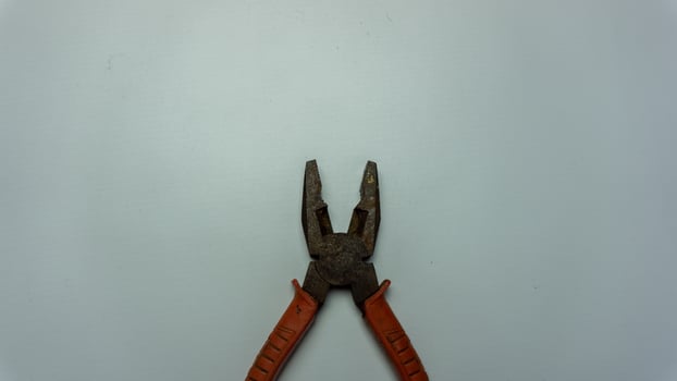 old and rusty pliers isolated on white photo