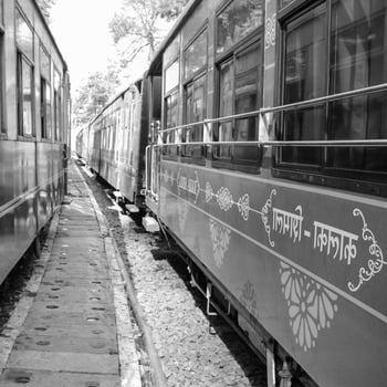 Toy Train moving on mountain slope, beautiful view, one side mountain, one side valley moving on railway to the hill, among green natural forest. Toy train from Kalka to Shimla in India photo
