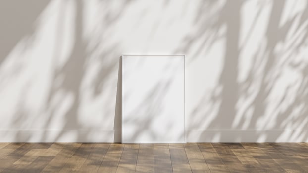 Frame poster mockup on wooden floor with white wall and sunlight shadow overlay photo