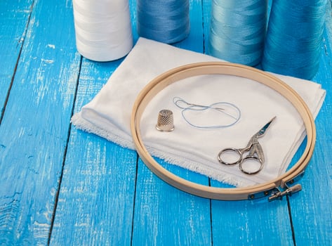 Threads in spools with white cloth for the embroidery and sewing photo