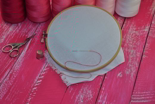 Sewing and embroidery on the wooden table photo