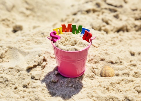 Pink metal baby bucket with sand photo