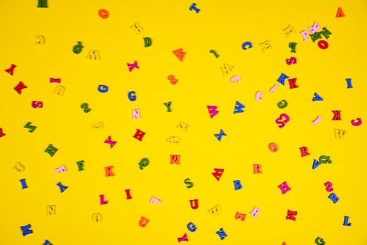 Yellow background with multi-colored wooden letters photo