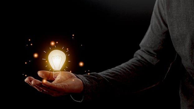 hand holding light bulb. idea concept with innovation and inspiration. Bulb light drawing idea in hand photo