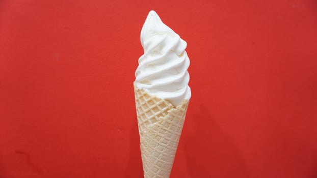 A cone of ice cream with a red background photo