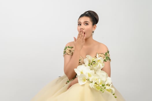 Young asian beautiful bride with orchid bouquet on white background photo
