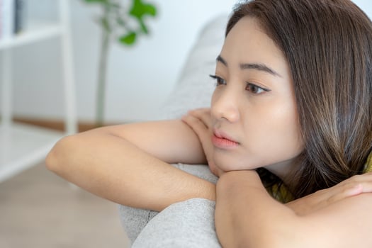 Depression and mental illness. Asian woman disappointed, sad after receiving bad news. Stressed girl confused with unhappy problems, arguing with boyfriend, cry and worry about unexpected pregnancy. photo