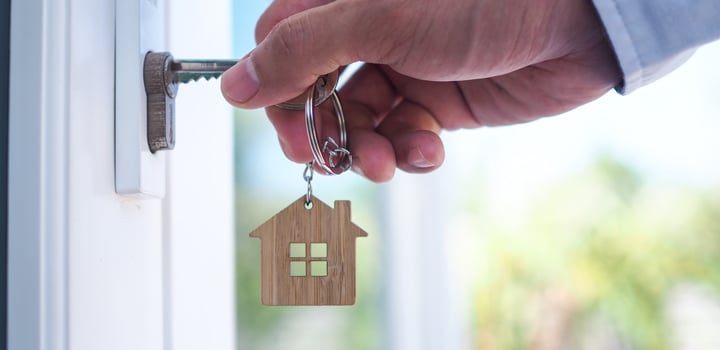 Landlord unlocks the house key for new home photo