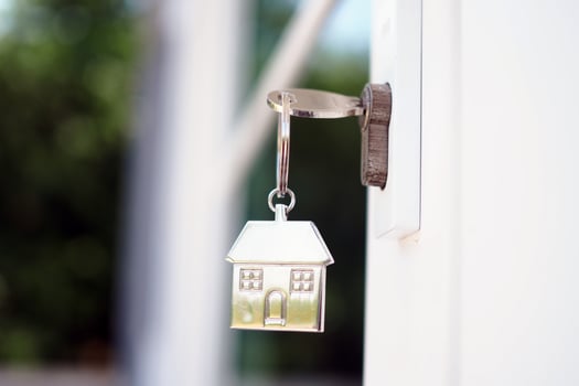 Home key for unlocking the new house door. Renting, buying, selling houses photo