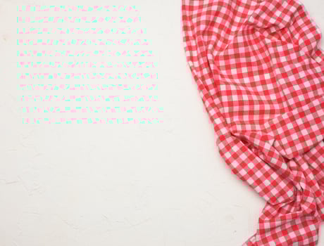 folded cotton red white checkered napkin on a white background photo