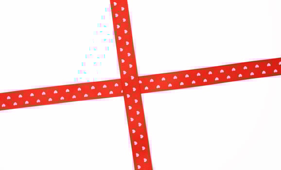 red satin ribbon cross to cross on white background photo