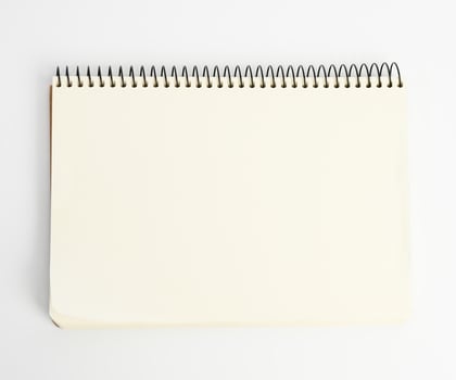 open spiral notepad with blank white sheets on white background photo