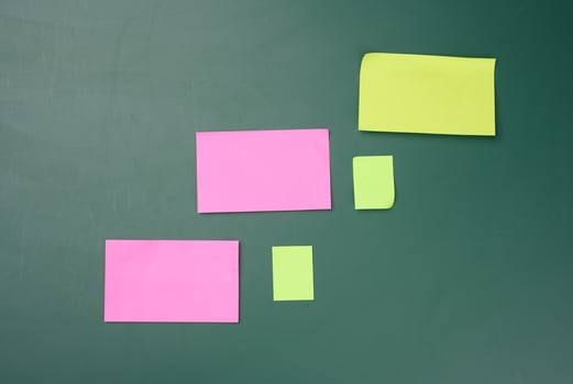 multicolored paper sticks are glued to the green board photo