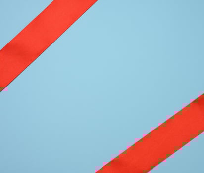 red silk ribbon on a blue background, festive backdrop photo