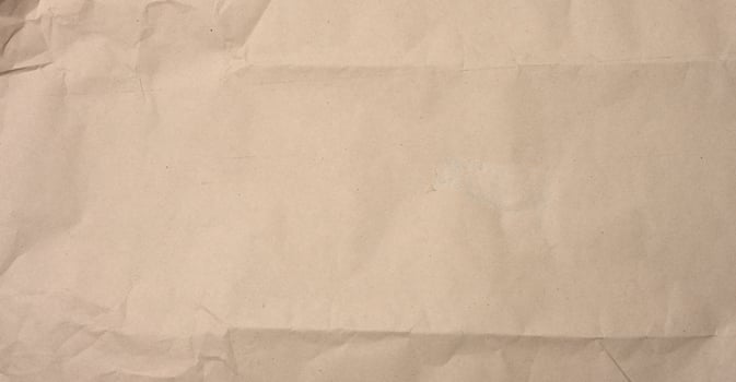 crumpled blank sheet of brown wrapping kraft paper photo