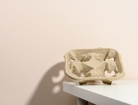 paper cardboard holder for cups on a white table photo