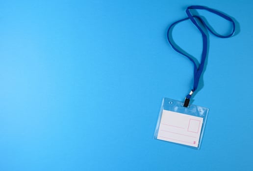 transparent plastic badge on a blue lanyard on a blue background photo