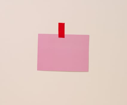 blank rectangular pink sheet of paper glued on a light blue background. Place for an inscription, announcement photo