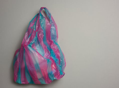 full plastic bag on gray background, top view photo