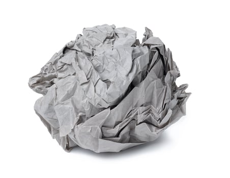 Crumpled gray sheet of paper isolated on white background photo