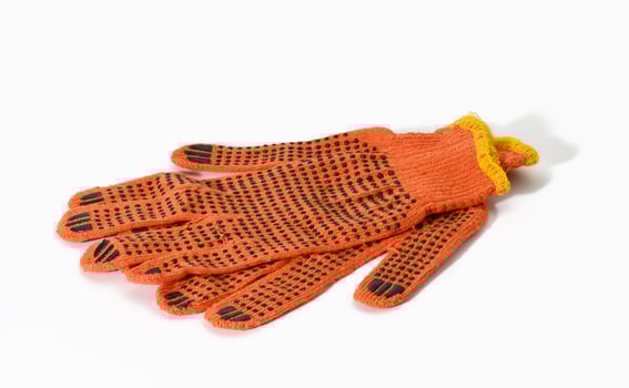 textile orange work gloves on a white background. Protective clothing for manual workers photo