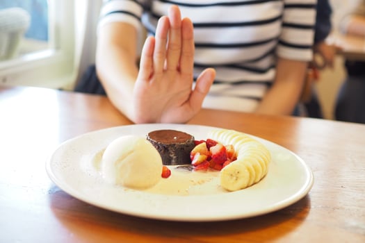 The women used to push the dessert plate with the people.  Do not eat desserts for weight loss. photo
