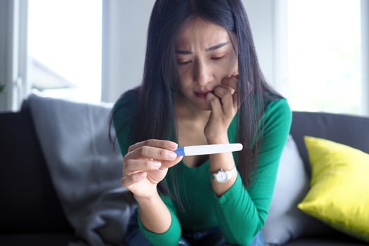 Asian beautiful women are stressed and worried about pregnancy results. Pregnancy beyond expectations in teenagers photo