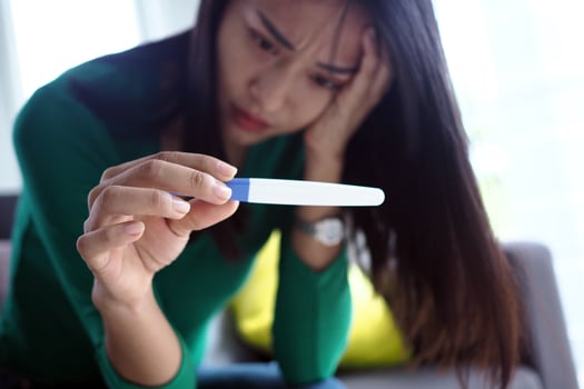 Asian beautiful women are stressed and worried about pregnancy results. Pregnancy beyond expectations in teenagers photo
